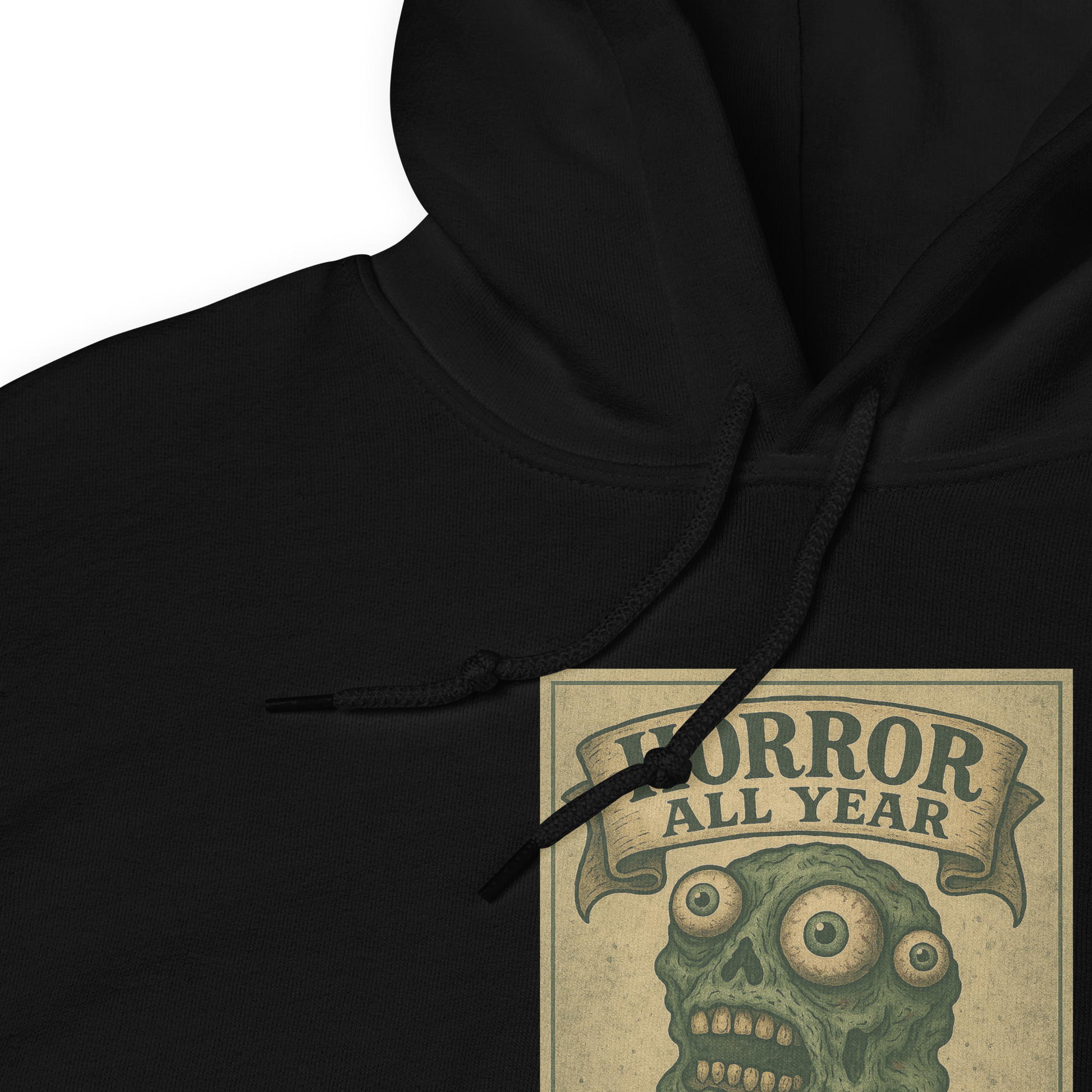 This is a zoom in of a black hoodie that is a vintage-style illustration of a zombie-themed ice cream cone with a green, melting undead face and bulging eyeballs. Above the cone, a horror banner reads "Horror All Year" on a distressed parchment background