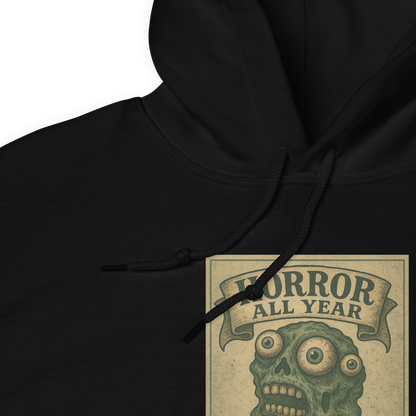 This is a zoom in of a black hoodie that is a vintage-style illustration of a zombie-themed ice cream cone with a green, melting undead face and bulging eyeballs. Above the cone, a horror banner reads "Horror All Year" on a distressed parchment background