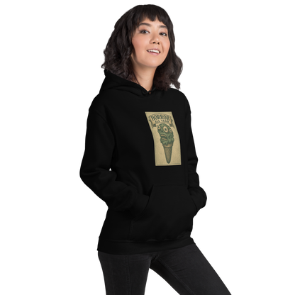 This is a woman with dark hair wearing a black hoodie that is a vintage-style illustration of a zombie-themed ice cream cone with a green, melting undead face and bulging eyeballs. Above the cone, a horror banner reads "Horror All Year" on a distressed parchment background