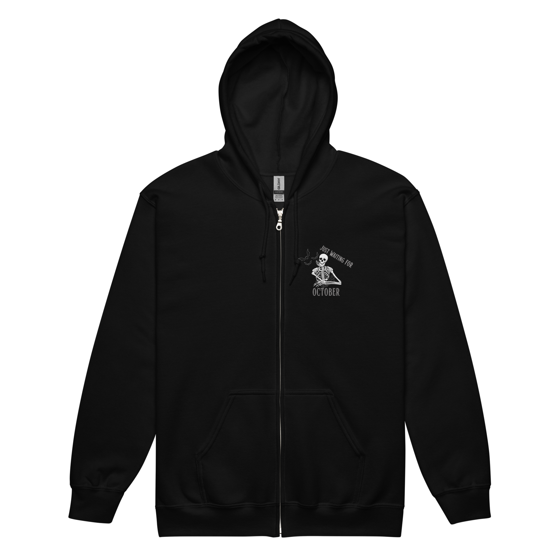 This is a black zip-up hoodie that has a bored skeleton with his head resting in his hand and he has spider webs and bats around him and the text reads just waiting for October