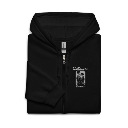 This is a folded black zip-up hoodie that has a hugging skeleton couple that is grey and says Halloween Forever 