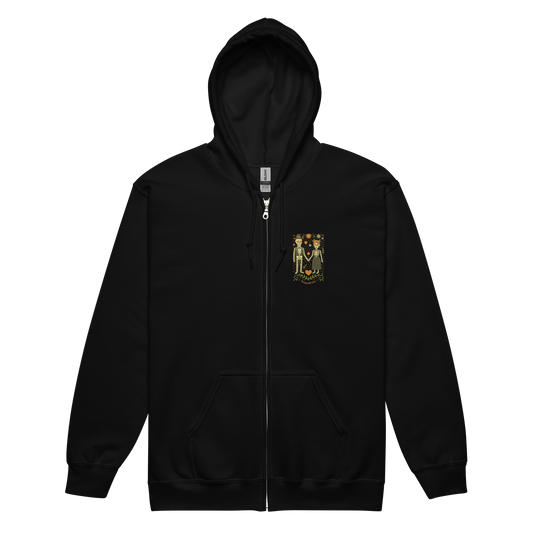 This is a black zip up hoodie with a Día de los Muertos–style illustration of a male and female skeleton holding hands, surrounded by marigolds, vines, and folk art patterns. The skeletons wear traditional black clothing, the man in a suit and hat, the woman with a floral crown with a red heart and leaves at the bottom and the text Creepy All Year. Rendered in warm tones of orange, green, and cream, symbolizing eternal love and remembrance
