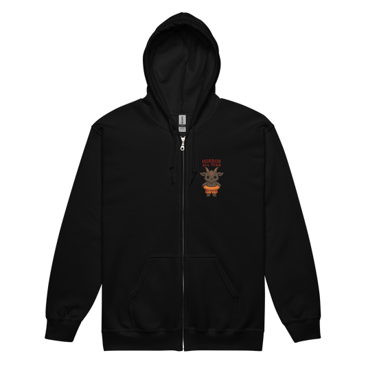 This is a black zip-up hoodie with a cartoon illustration of a baby Baphomet goat with curved horns and a playful grin, wearing bright floral swim trunks while floating in a colorful inner tube. The character is set against a light background with the bold text “Horror All Year” above in red letters