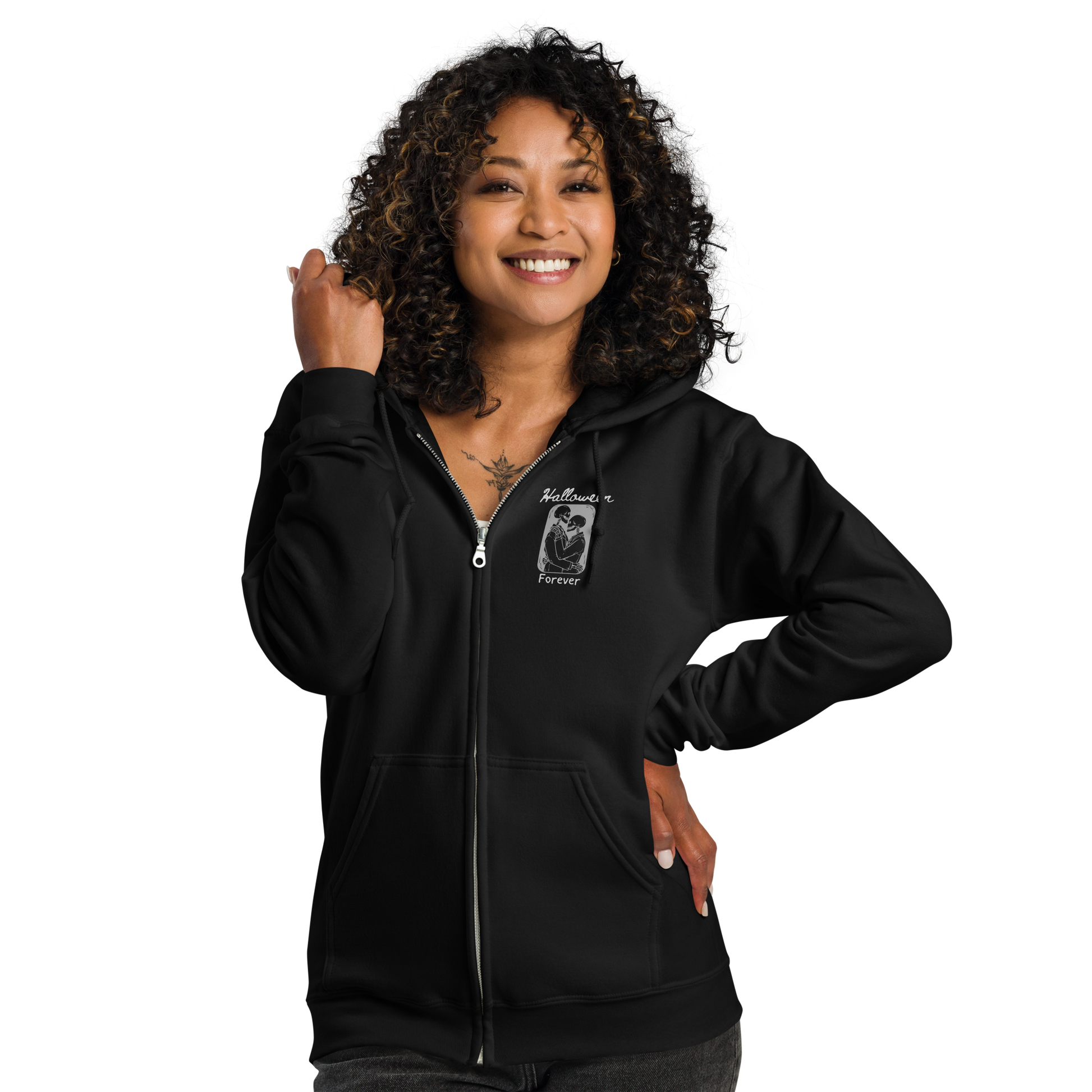 This is a woman with black hair wearing a black zip-up hoodie that has a hugging skeleton couple that is grey and says Halloween Forever 