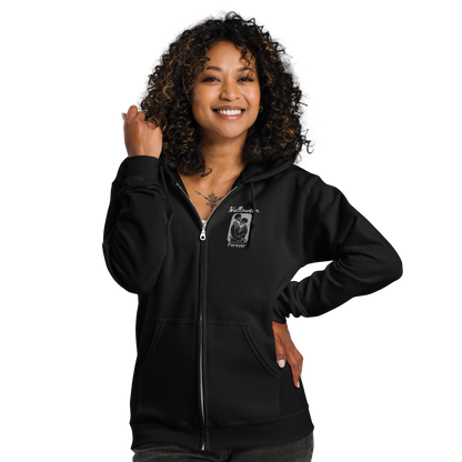 This is a woman with black hair wearing a black zip-up hoodie that has a hugging skeleton couple that is grey and says Halloween Forever 