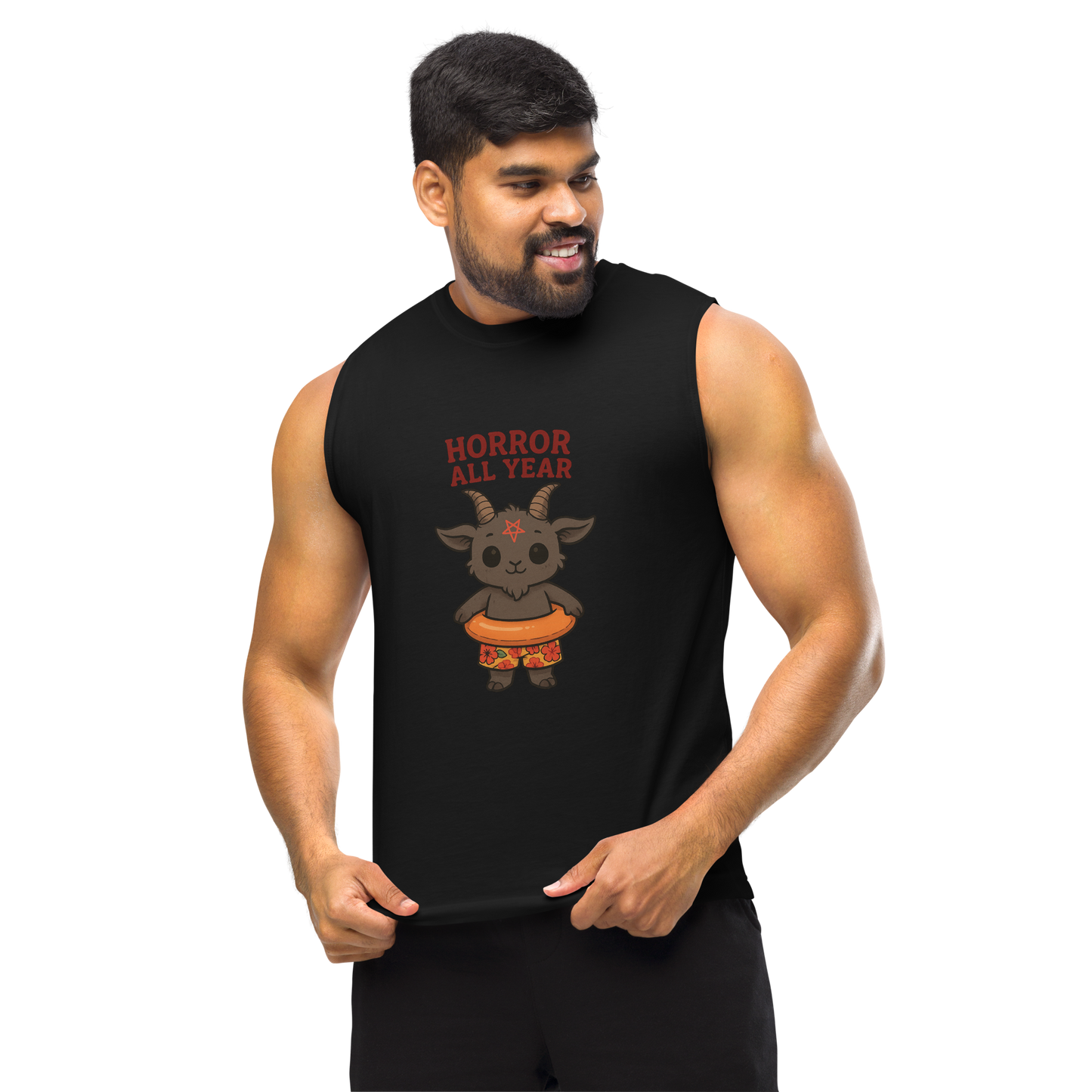 This is a man with dark hair wearing a black muscle shirt with a cartoon illustration of a baby Baphomet goat with curved horns and a playful grin, wearing bright floral swim trunks while floating in a colorful inner tube. The character is set against a light background with the bold text “Horror All Year” above in red letters