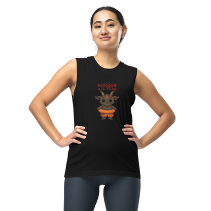This is a woman with dark hair wearing a black muscle shirt with a cartoon illustration of a baby Baphomet goat with curved horns and a playful grin, wearing bright floral swim trunks while floating in a colorful inner tube. The character is set against a light background with the bold text “Horror All Year” above in red letters