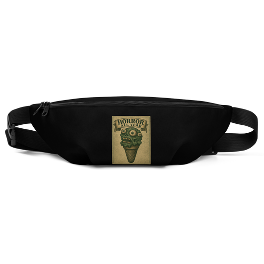 This is a black waist bag fanny pack that is a vintage-style illustration of a zombie-themed ice cream cone with a green, melting undead face and bulging eyeballs. Above the cone, a horror banner reads "Horror All Year" on a distressed parchment background