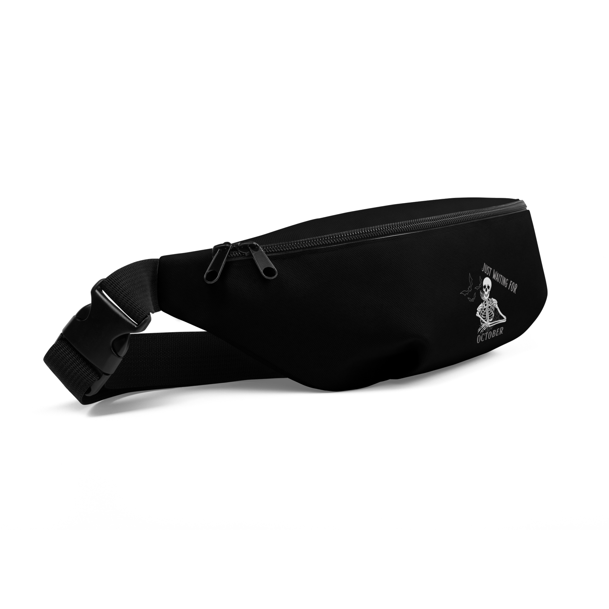 This is a black waist bag fanny pack that has a bored skeleton with his head resting in his hand and he has spider webs and bats around him and the text reads just waiting for October