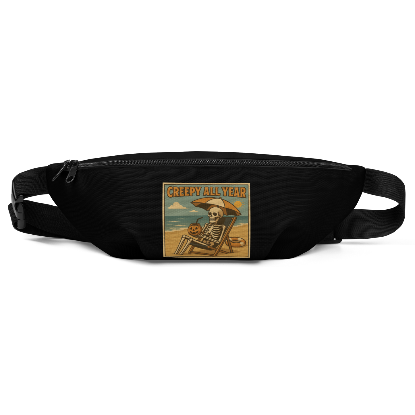 This is a black waist bag fanny pack with a retro-style illustration of a grinning skeleton lounging on a beach chair under an orange umbrella. The skeleton is holding a pumpkin-shaped drink cup with a straw and relaxing by the ocean, with a bright sun in the sky and a life preserver in the sand. The words “Creepy All Year” appear boldly at the top 