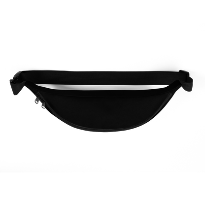 This is the top of a black waist bag fanny pack with a retro-style illustration of a grinning skeleton lounging on a beach chair under an orange umbrella. The skeleton is holding a pumpkin-shaped drink cup with a straw and relaxing by the ocean, with a bright sun in the sky and a life preserver in the sand. The words “Creepy All Year” appear boldly at the top 