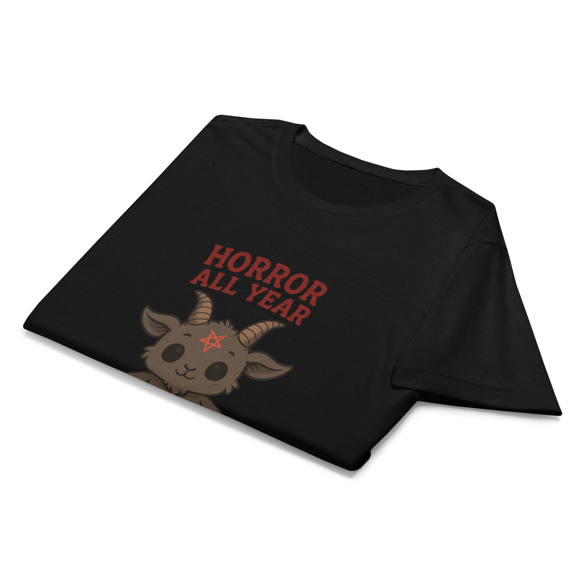 This is a folded black t-shirt with a cartoon illustration of a baby Baphomet goat with curved horns and a playful grin, wearing bright floral swim trunks while floating in a colorful inner tube. The character is set against a light background with the bold text “Horror All Year” above in red letters