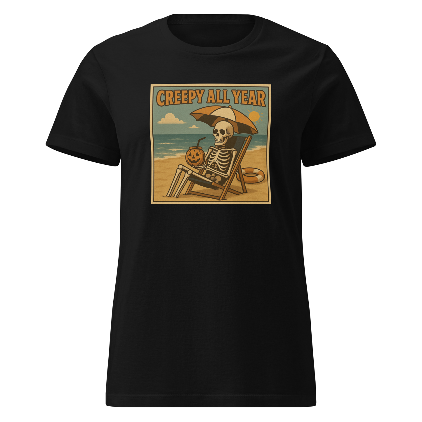This is a black style woman's t-shirt with a retro-style illustration of a grinning skeleton lounging on a beach chair under an orange umbrella. The skeleton is holding a pumpkin-shaped drink cup with a straw and relaxing by the ocean, with a bright sun in the sky and a life preserver in the sand. The words “Creepy All Year” appear boldly at the top