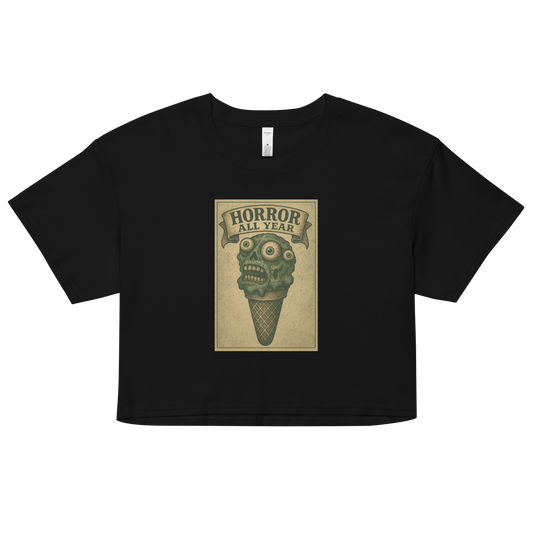This a black crop top that is a vintage-style illustration of a zombie-themed ice cream cone with a green, melting undead face and bulging eyeballs. Above the cone, a horror banner reads "Horror All Year" on a distressed parchment background