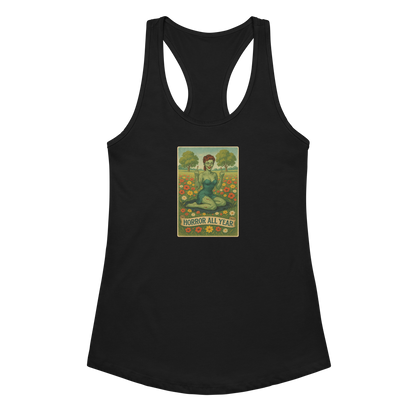This is a black racerback tank top with a design illustration of a sassy zombie pinup girl standing in a floral field, wearing tattered lingerie and flipping off the viewer with both hands. She has green skin, vintage curls, and a bold attitude. The design blends horror and humor, with a pastel color palette and creepy cute vibes