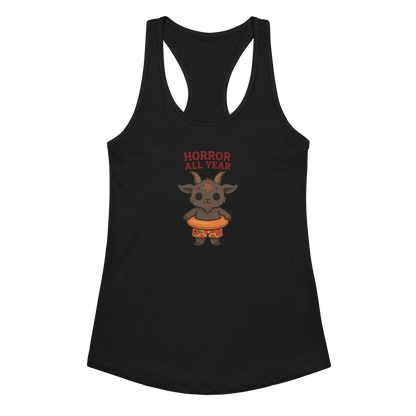 This is a black racerback tank top with a cartoon illustration of a baby Baphomet goat with curved horns and a playful grin, wearing bright floral swim trunks while floating in a colorful inner tube. The character is set against a light background with the bold text “Horror All Year” above in red letters