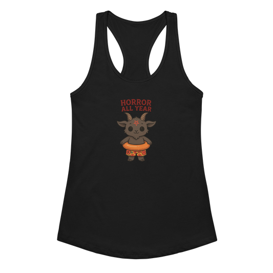 This is a black racerback tank top with a cartoon illustration of a baby Baphomet goat with curved horns and a playful grin, wearing bright floral swim trunks while floating in a colorful inner tube. The character is set against a light background with the bold text “Horror All Year” above in red letters
