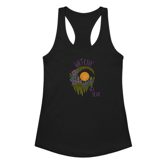 This is a black racerback tank top with a design of a hand-drawn wreath made of moss-covered branches wraps around a glowing sun. The wreath is decorated with purple and blue flowers, small amethyst and fluorite crystals, and strands of hanging moss. The words “Witchy” curve above the wreath and “All Year” sits on the bottom right 
