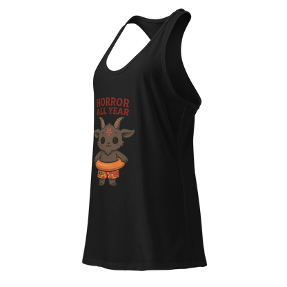This is a side view of a black racerback tank top with a cartoon illustration of a baby Baphomet goat with curved horns and a playful grin, wearing bright floral swim trunks while floating in a colorful inner tube. The character is set against a light background with the bold text “Horror All Year” above in red letters